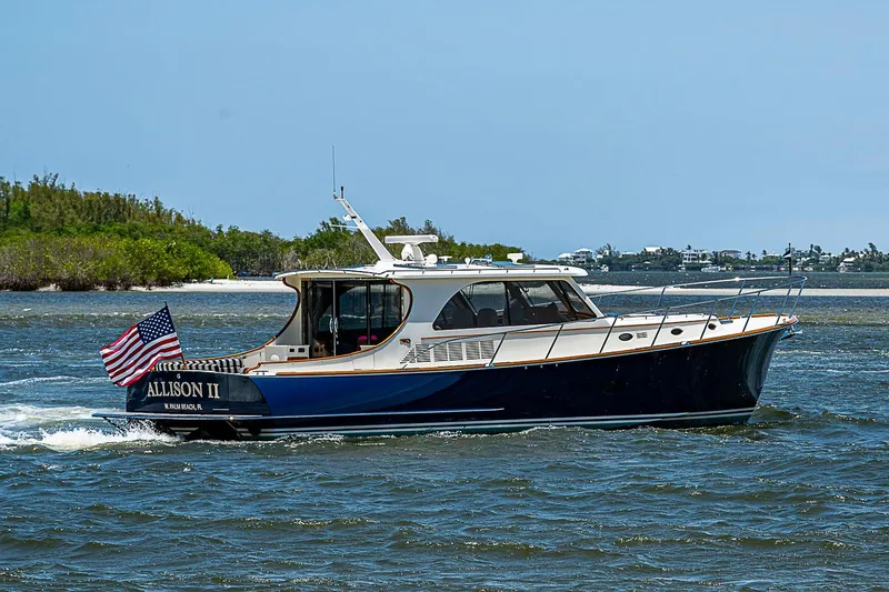 Slide: The Image of 2015 Hinckley Talaria 48 yacht cruising on open water with American flag. - 3