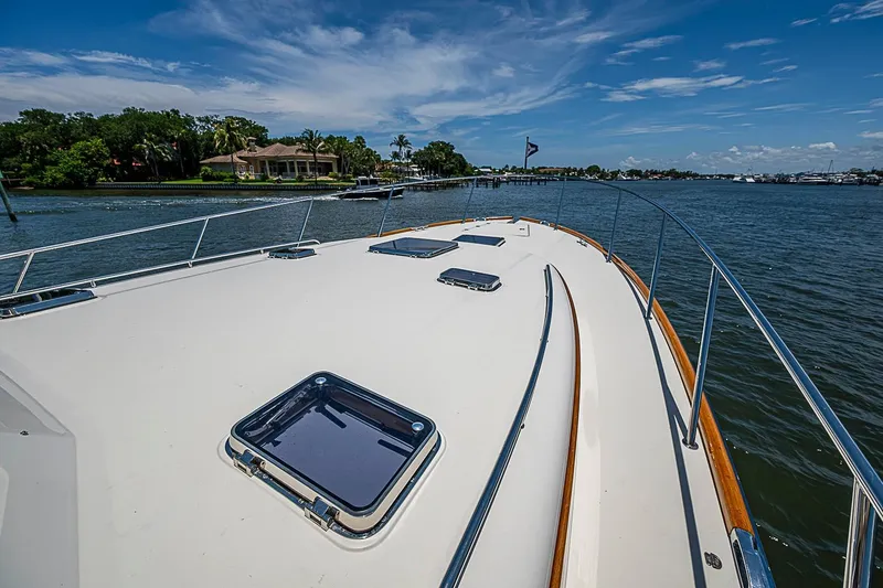 Slide: The Image of Hinckley Talaria 48 yacht deck, 2015 model, cruising on a sunny day with scenic waterfront views. - 30