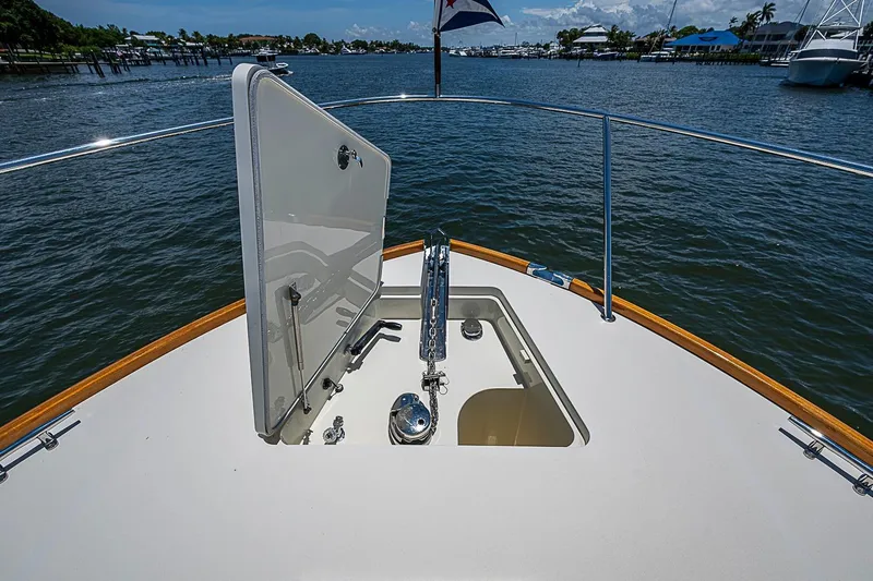 Slide: The Image of 2015 Hinckley Talaria 48 yacht deck with open hatch, overlooking serene waters. - 31
