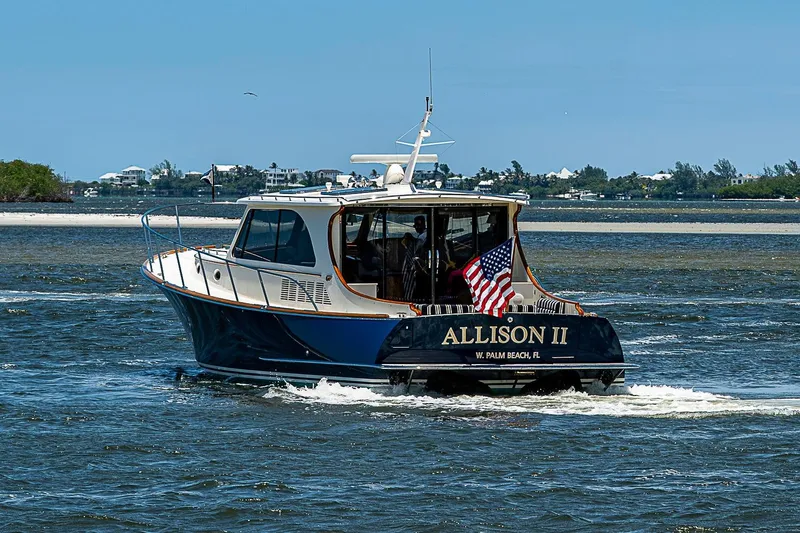 Slide: The Image of Hinckley Talaria 48 yacht cruising in coastal waters, 2015 model, with American flag displayed. - 4