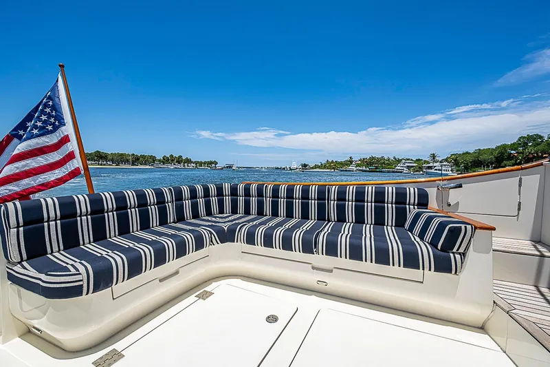 Slide: The Image of Hinckley Talaria 48 yacht deck with striped seating and American flag, 2015 model. - 7