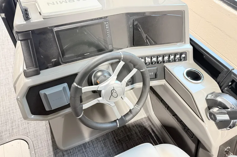 Slide: The Image of 2026 Qwest L-Class 20 RLS boat dashboard with steering wheel and control panel. - 15