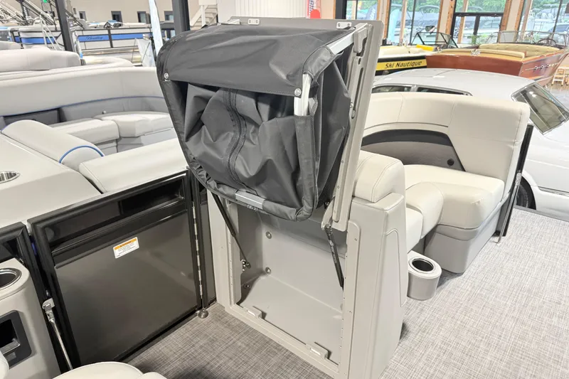 Slide: The Image of 2026 Qwest L-Class 20 RLS boat interior with seating and storage compartments. - 19