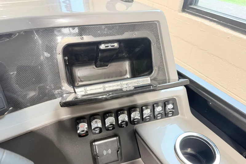 Slide: The Image of Control panel of 2026 Qwest L-Class 20 RLS boat with switches and cup holder. - 4