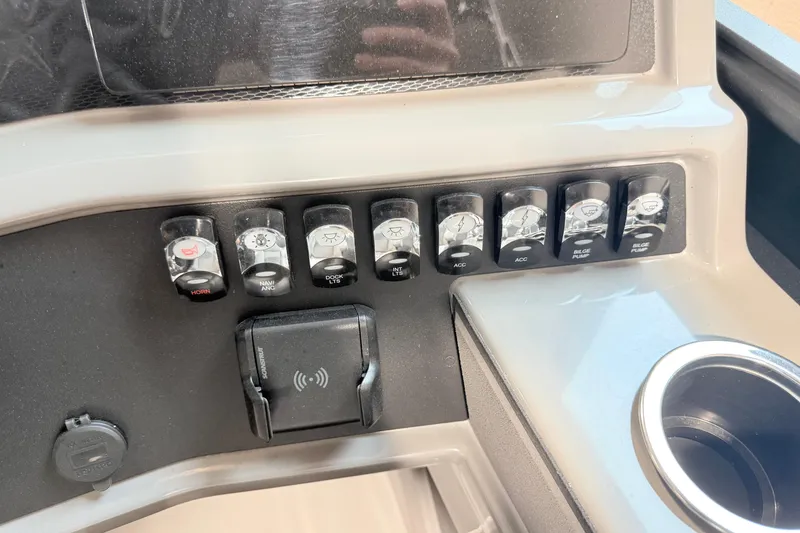 Slide: The Image of Control panel of 2026 Qwest L-Class 20 RLS boat with switches and cup holder. - 5
