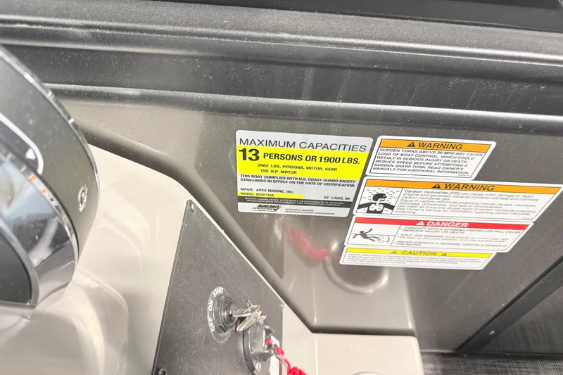 Slide: The Image of Capacity and warning labels on 2026 Qwest L-Class 20 RLS boat dashboard. - 6