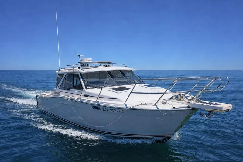 Slide: The Image of 2023 Cutwater C-288 Coupe cruising on open water under clear blue skies. - 0