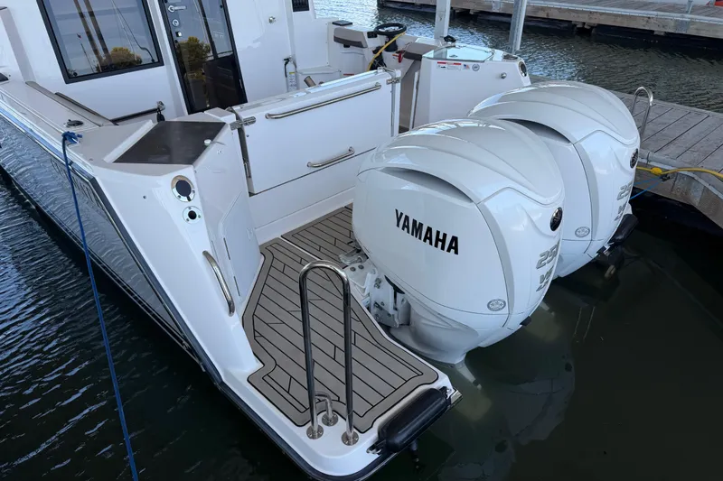 Slide: The Image of 2023 Cutwater C-288 Coupe with twin Yamaha outboard engines docked at marina. - 10