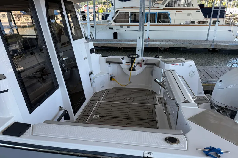Slide: The Image of 2023 Cutwater C-288 Coupe boat interior at dock, showcasing cockpit and seating area. - 11