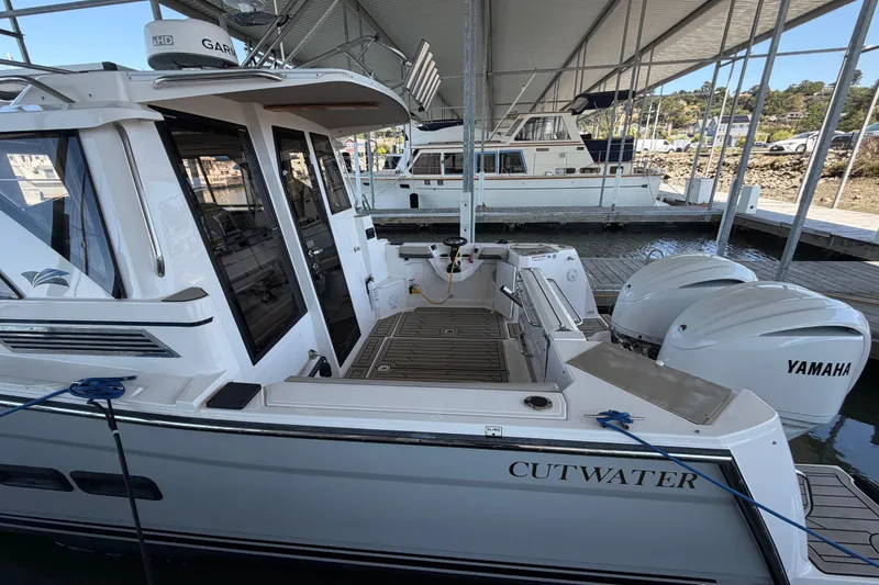 Slide: The Image of 2023 Cutwater C-288 Coupe docked, featuring dual Yamaha outboard engines under a covered marina. - 12