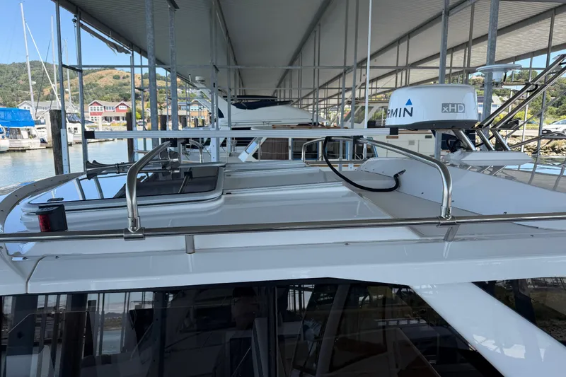 Slide: The Image of 2023 Cutwater C-288 Coupe docked under a marina roof, showcasing sleek design and radar equipment. - 14