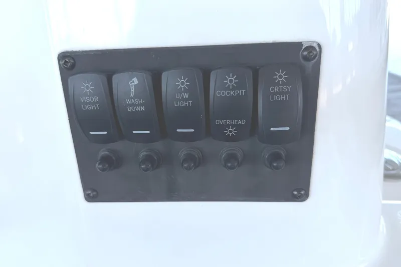 Slide: The Image of Control panel with light switches on 2023 Cutwater C-288 Coupe boat. - 17
