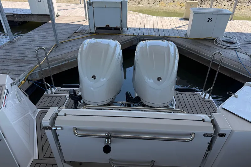 Slide: The Image of 2023 Cutwater C-288 Coupe with dual outboard engines docked at a marina. - 21