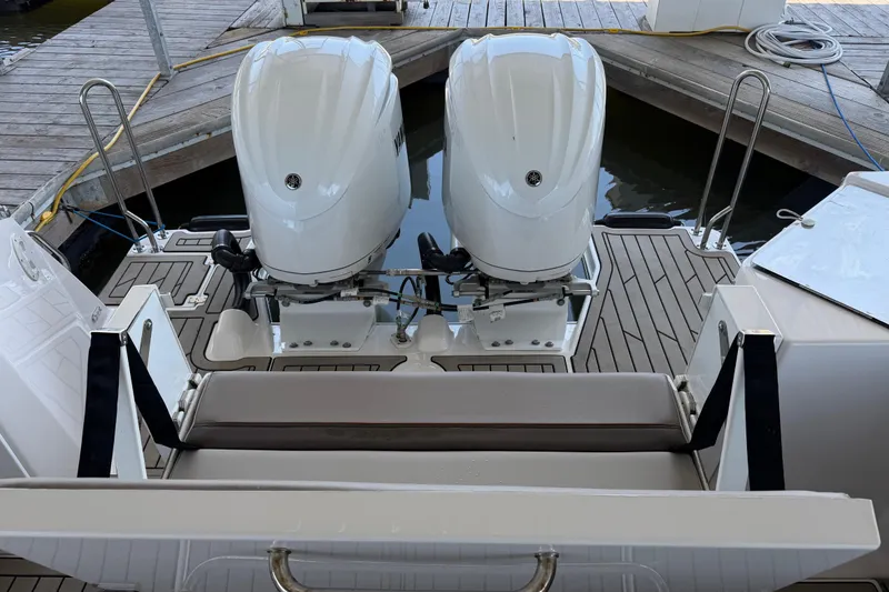 Slide: The Image of 2023 Cutwater C-288 Coupe with dual outboard engines on a wooden dock. - 22