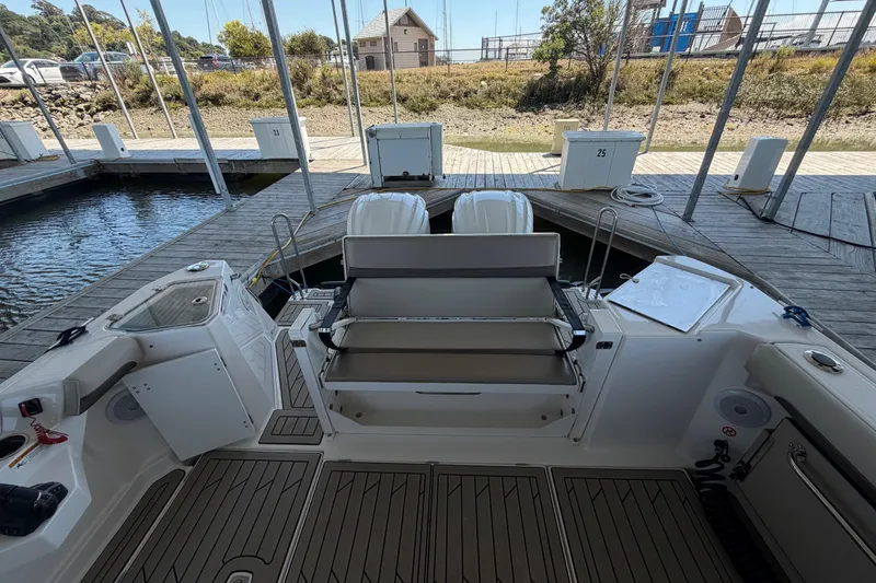 Slide: The Image of 2023 Cutwater C-288 Coupe boat docked, featuring spacious deck and seating area. - 25