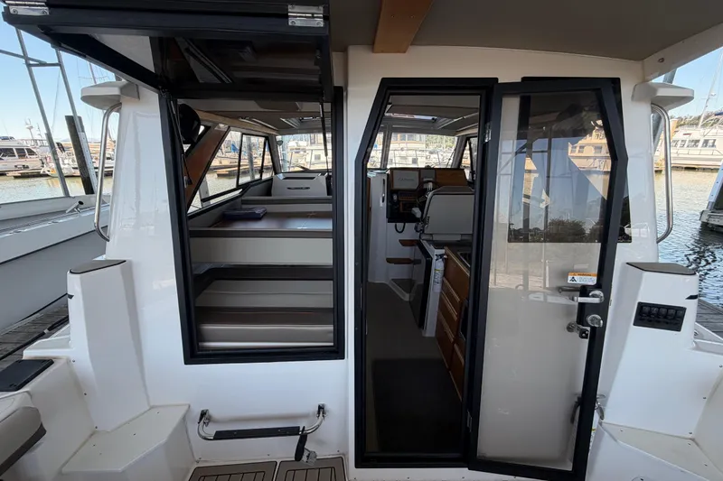 Slide: The Image of 2023 Cutwater C-288 Coupe interior view, showcasing cabin and helm station at the marina. - 27