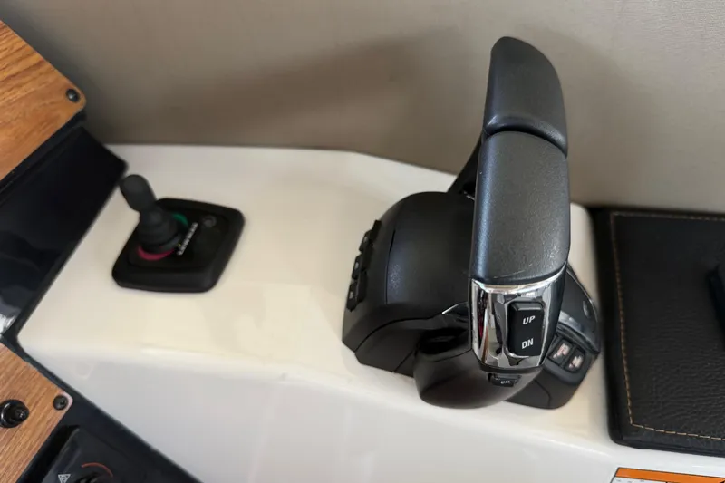 Slide: The Image of 2023 Cutwater C-288 Coupe throttle and joystick controls on a sleek dashboard. - 35