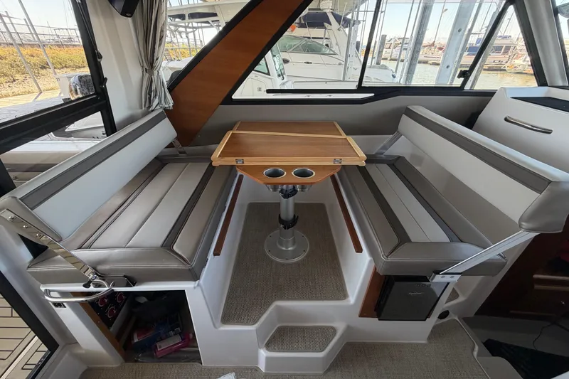 Slide: The Image of Interior of 2023 Cutwater C-288 Coupe featuring a cozy dining area with cushioned seating. - 42