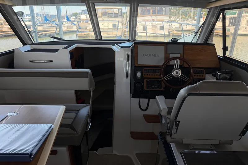 Slide: The Image of Interior of 2023 Cutwater C-288 Coupe boat, featuring helm with Garmin navigation system. - 45