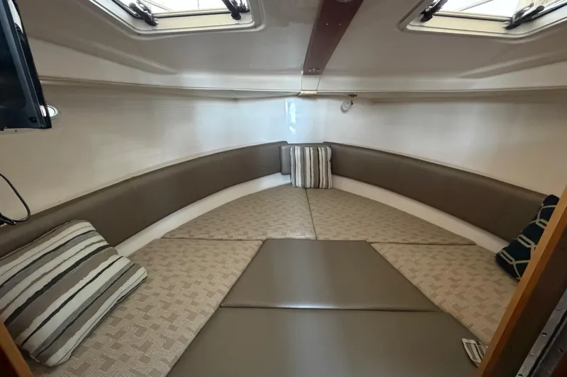 Slide: The Image of 2023 Cutwater C-288 Coupe interior cabin with cozy seating and striped cushions. - 47