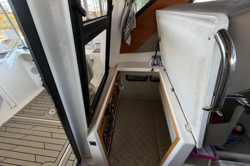 Slide: The Image of 2023 Cutwater C-288 Coupe interior with open storage compartment and modern design. - 54