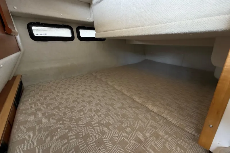 Slide: The Image of Interior cabin space of 2023 Cutwater C-288 Coupe with patterned flooring and small windows. - 55