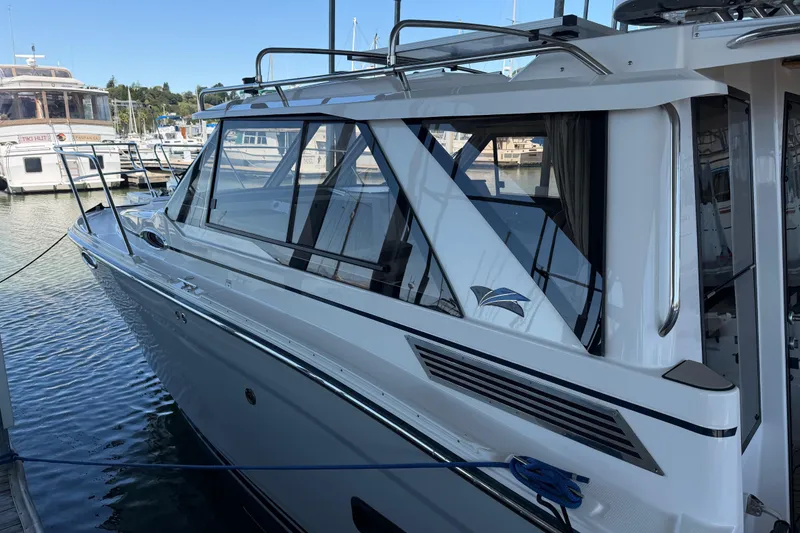 Slide: The Image of 2023 Cutwater C-288 Coupe docked at a marina, showcasing sleek design and modern features. - 6