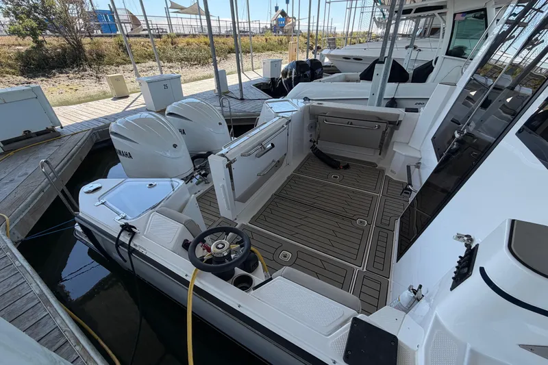 Slide: The Image of 2023 Cutwater C-288 Coupe boat with Yamaha engines docked at marina. - 8