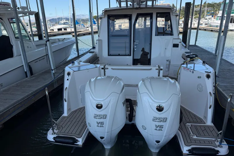 Slide: The Image of 2023 Cutwater C-288 Coupe with twin 250 V6 engines docked at a marina. - 9