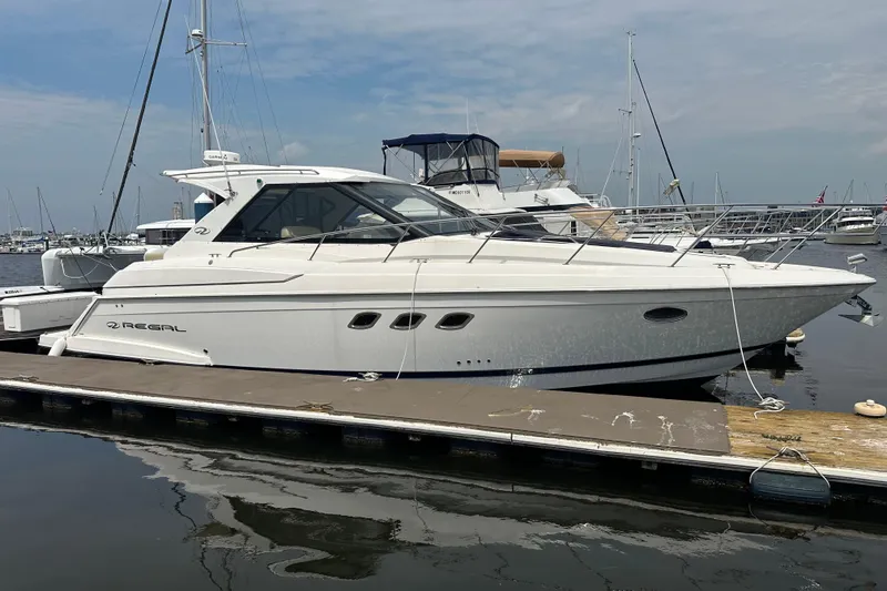 The Image of 2012 Regal 42 Sport Coupe yacht docked at marina, side view. - 0