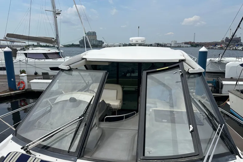 Slide: The Image of 2012 Regal 42 Sport Coupe docked at marina with open cockpit view. - 10