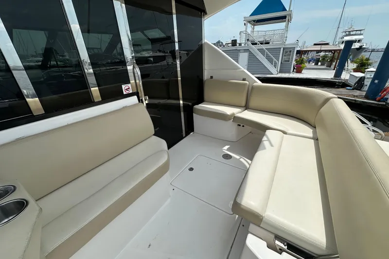 Slide: The Image of Luxurious seating area on a 2012 Regal 42 Sport Coupe yacht at a marina. - 12