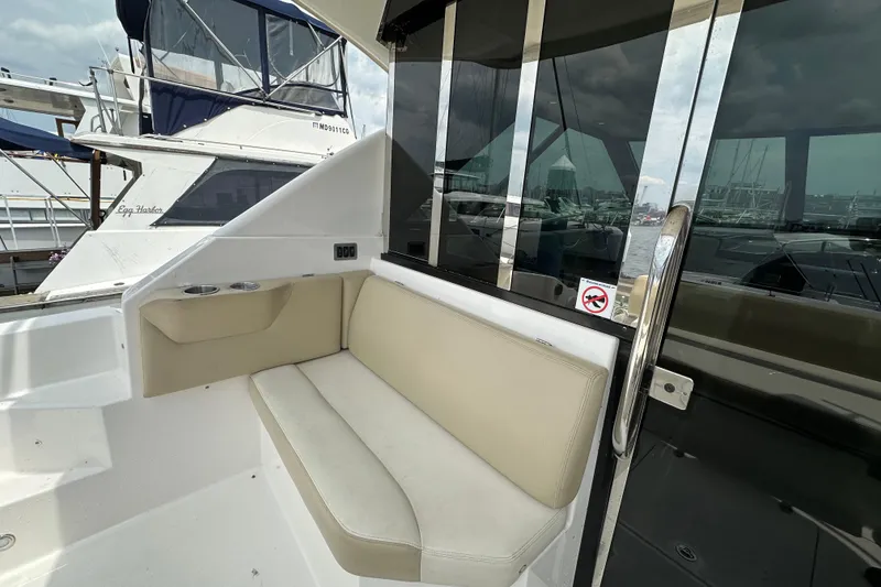 Slide: The Image of 2012 Regal 42 Sport Coupe yacht interior with beige seating and glass door. - 13