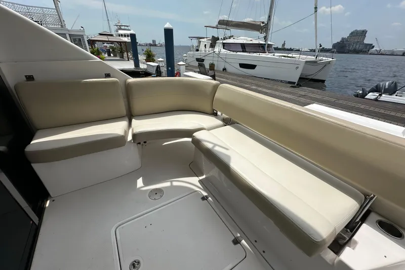 Slide: The Image of Luxurious seating area on a 2012 Regal 42 Sport Coupe yacht docked at a marina. - 14