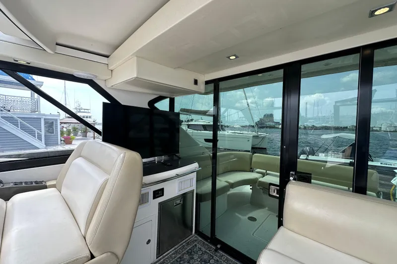 Slide: The Image of Interior of 2012 Regal 42 Sport Coupe yacht with luxurious seating and waterfront view. - 15