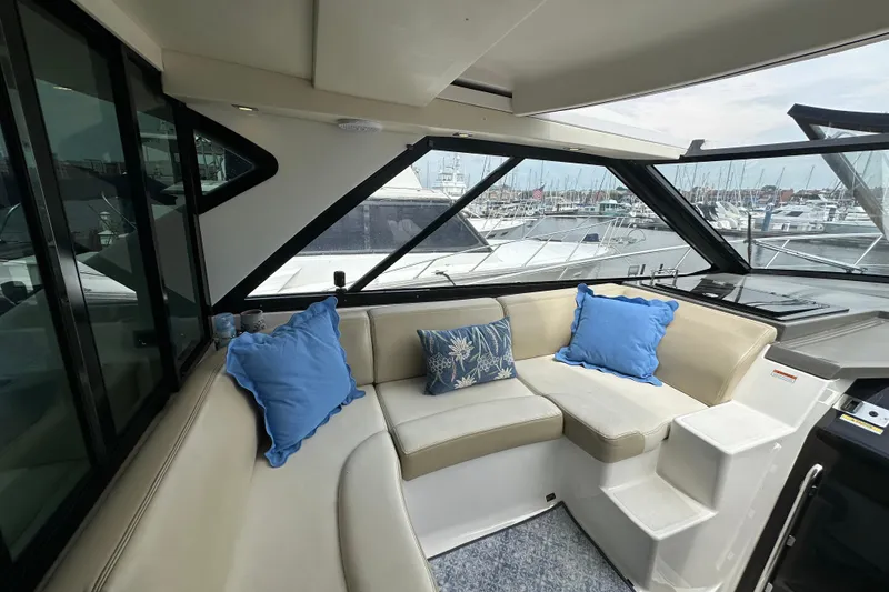 Slide: The Image of Luxurious interior of 2012 Regal 42 Sport Coupe yacht with plush seating and marina view. - 16