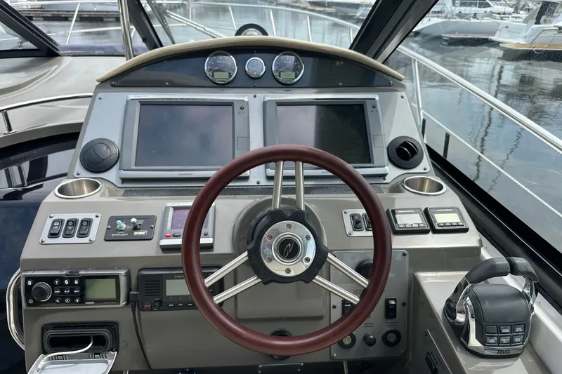 Slide: The Image of Cockpit of 2012 Regal 42 Sport Coupe with steering wheel and navigation controls. - 19