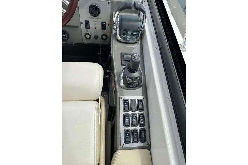 Slide: The Image of Control panel of a 2012 Regal 42 Sport Coupe boat with joystick and switches. - 20