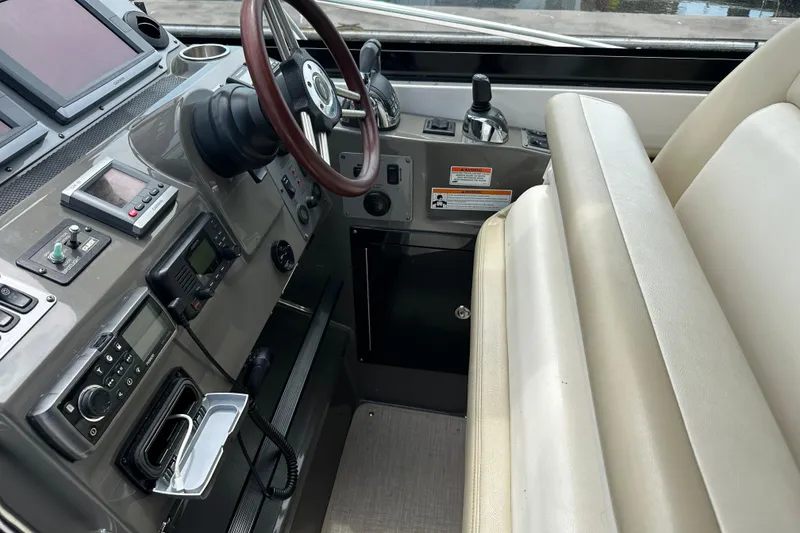 Slide: The Image of 2012 Regal 42 Sport Coupe helm with steering wheel, controls, and navigation equipment. - 21