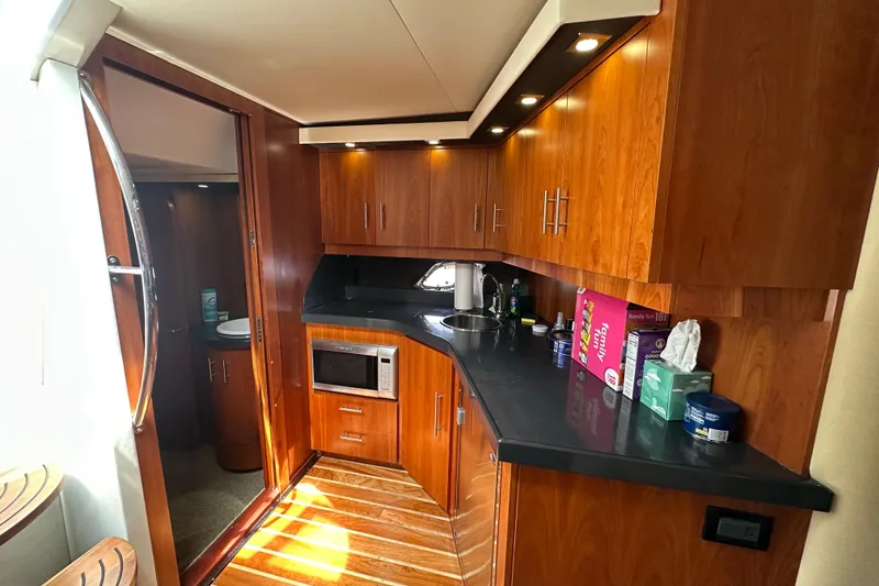 Slide: The Image of Luxurious 2012 Regal 42 Sport Coupe yacht interior with modern kitchen amenities. - 25