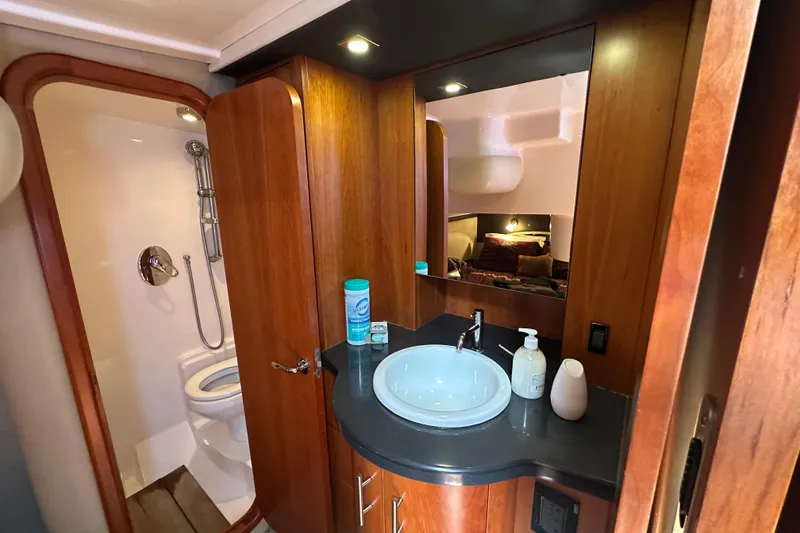 Slide: The Image of Luxurious 2012 Regal 42 Sport Coupe bathroom with wood cabinetry and modern fixtures. - 27