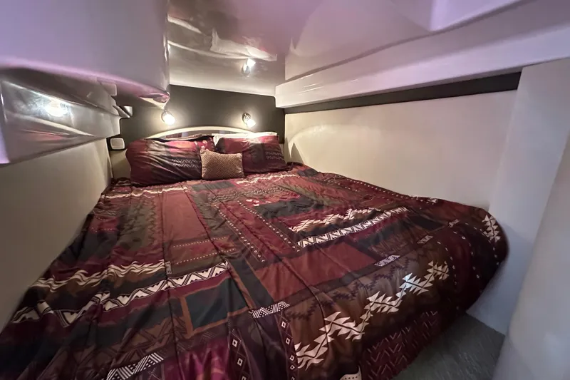 Slide: The Image of Luxurious cabin interior of 2012 Regal 42 Sport Coupe with patterned bedding. - 28