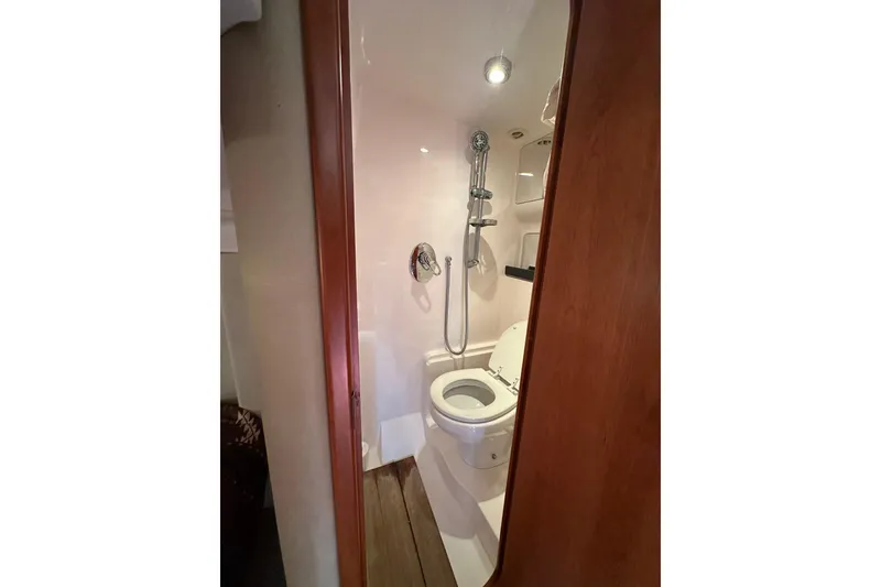 Slide: The Image of Bathroom interior of 2012 Regal 42 Sport Coupe yacht, featuring shower and toilet. - 29
