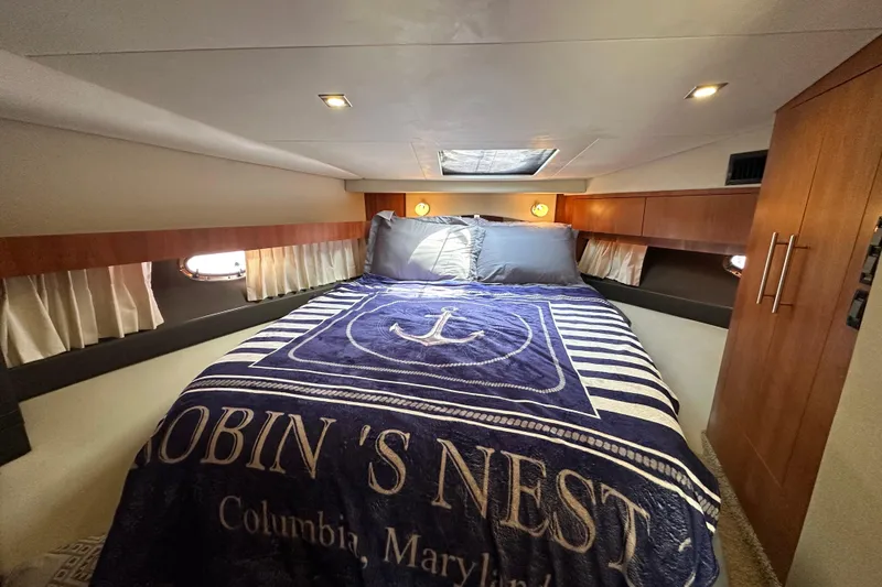 Slide: The Image of Cozy bedroom in 2012 Regal 42 Sport Coupe yacht with nautical-themed bedding. - 32