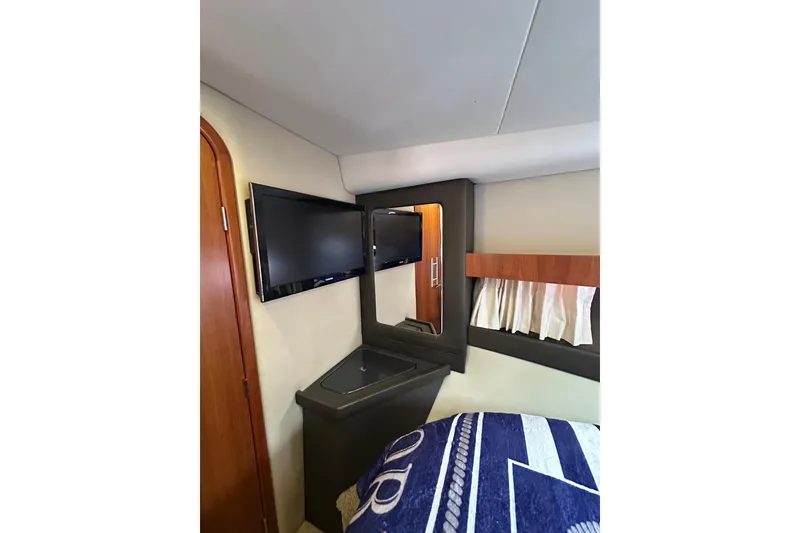 Slide: The Image of Interior of 2012 Regal 42 Sport Coupe with TV, mirror, and cozy bedding. - 34