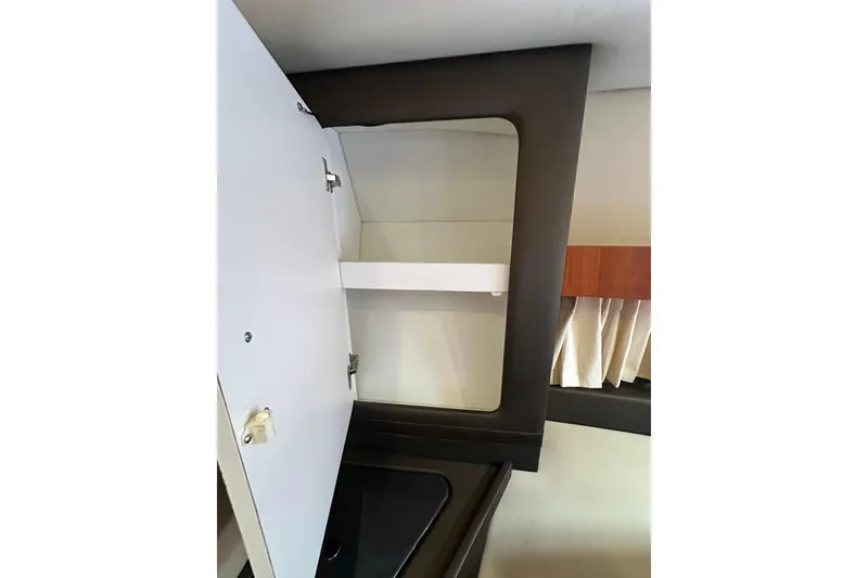 Slide: The Image of Interior cabinet of 2012 Regal 42 Sport Coupe yacht, featuring open storage space. - 35
