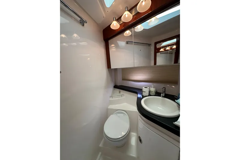 Slide: The Image of Luxurious bathroom in 2012 Regal 42 Sport Coupe yacht with modern fixtures and elegant lighting. - 37