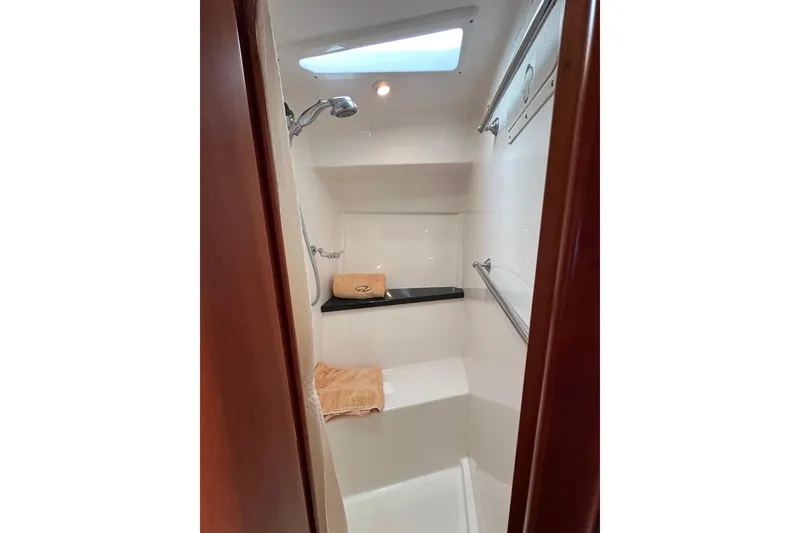 Slide: The Image of Shower area in 2012 Regal 42 Sport Coupe yacht with skylight and towels. - 38