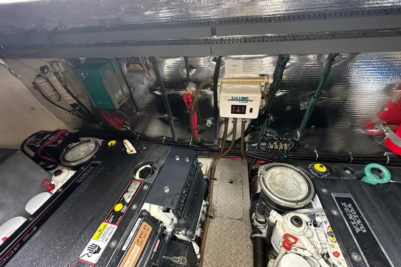 Slide: The Image of Engine room of a 2012 Regal 42 Sport Coupe with visible machinery and wiring. - 44