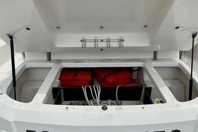 Slide: The Image of Open storage compartment on 2012 Regal 42 Sport Coupe with life jackets and ropes. - 46